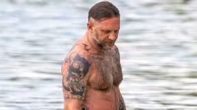 Hardy spotted on Barbados beach with wife Charlotte Riley during vacation