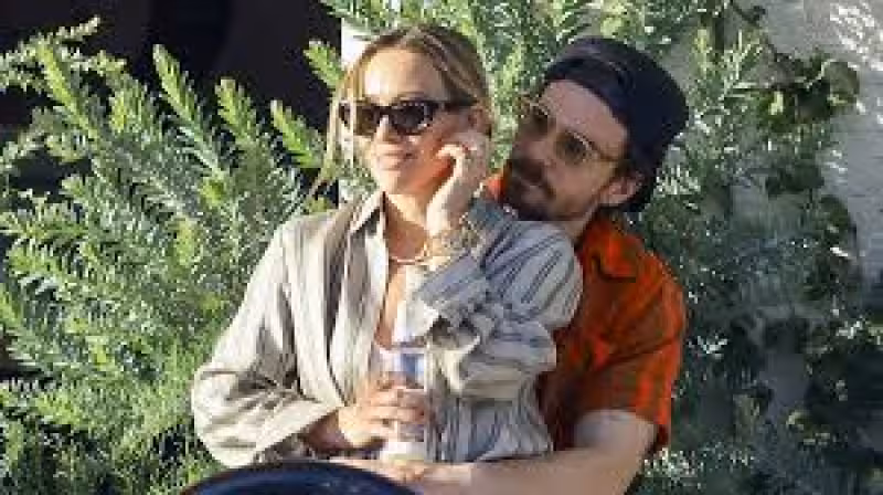 Hilary Duff sits on her husband Matthew Koma's lap before lunch in Studio City